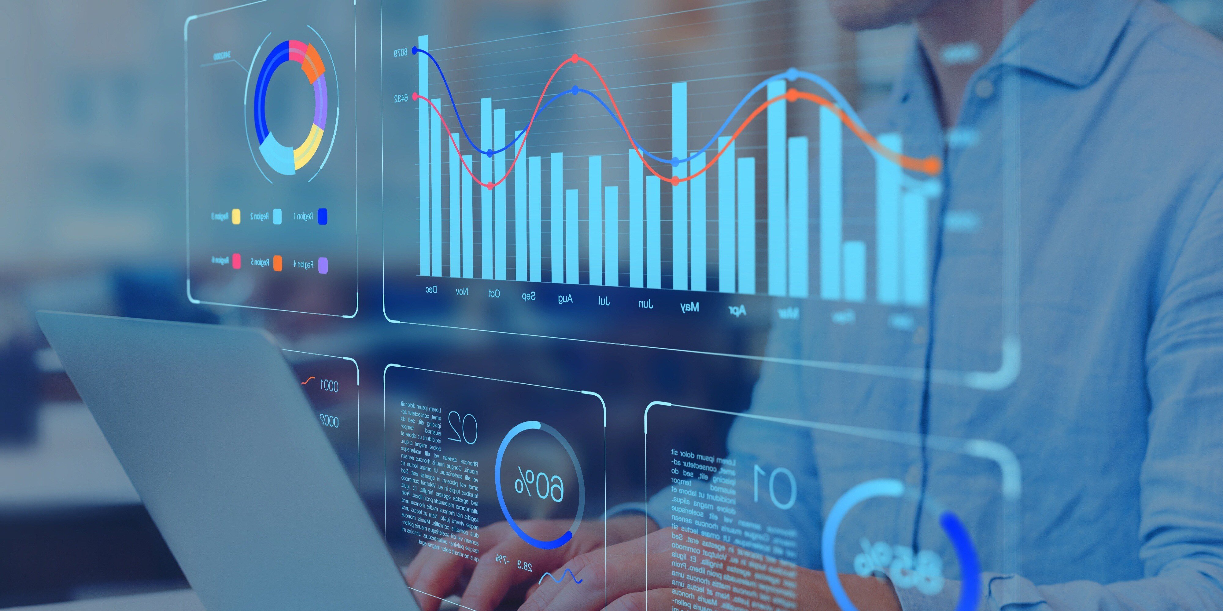 A person working on a laptop with transparent digital graphs and data visualizations projected in front